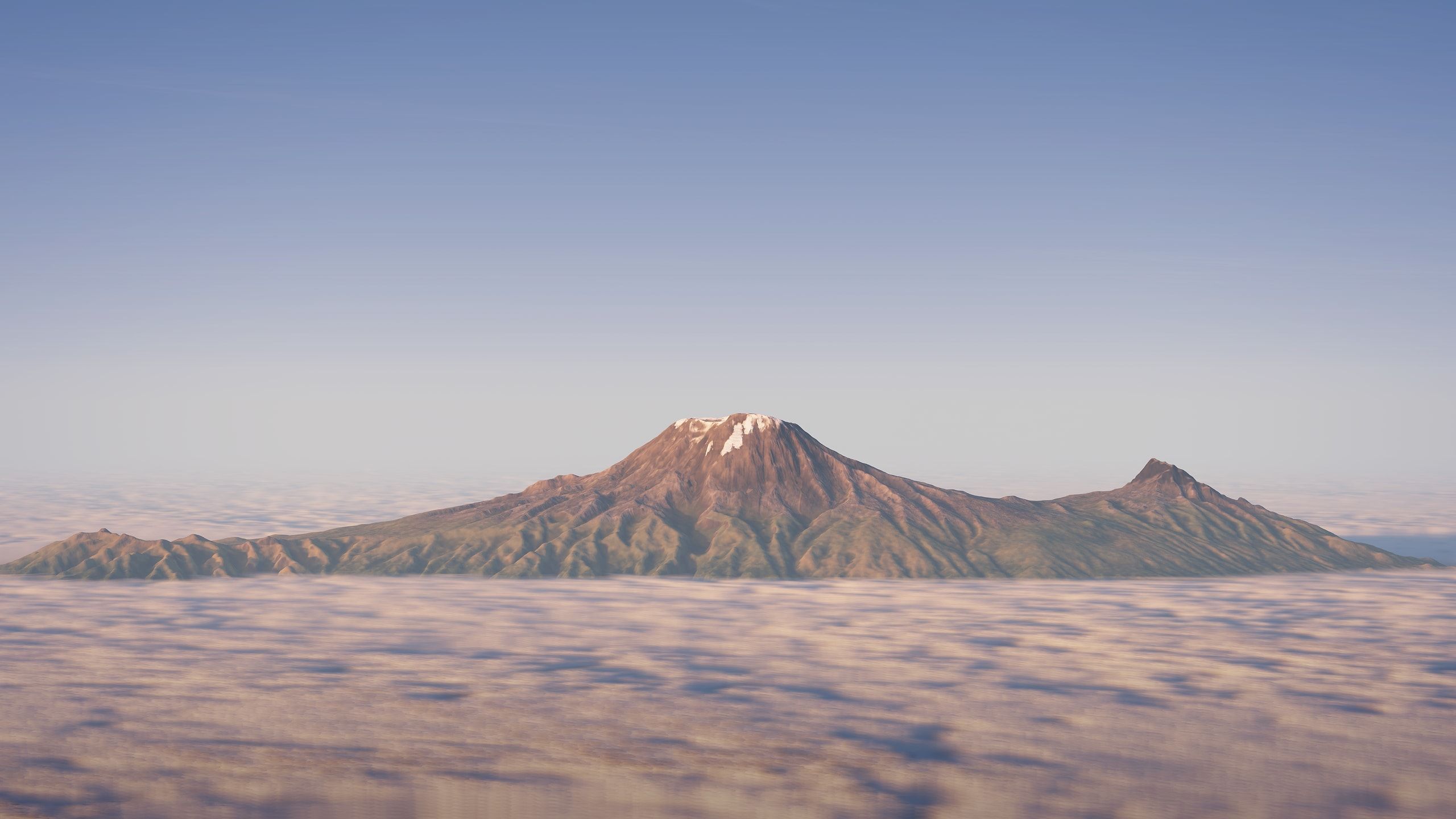 Aerial view of the Kilimanjaro massif with Kibo and Mawenzi rising above the clouds